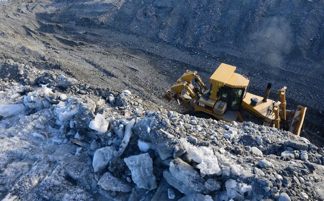 A 354th Civil Engineer Squadron Airman operates a bulldozer March 2, 2016, in Delta Junction, Alaska. The bulldozer pushes dirt to an excavator to load into rock trucks, which haul the dirt to a different area to create a trail system. (U.S. Air Force photo by Airman 1st Class Cassandra Whitman/Released)