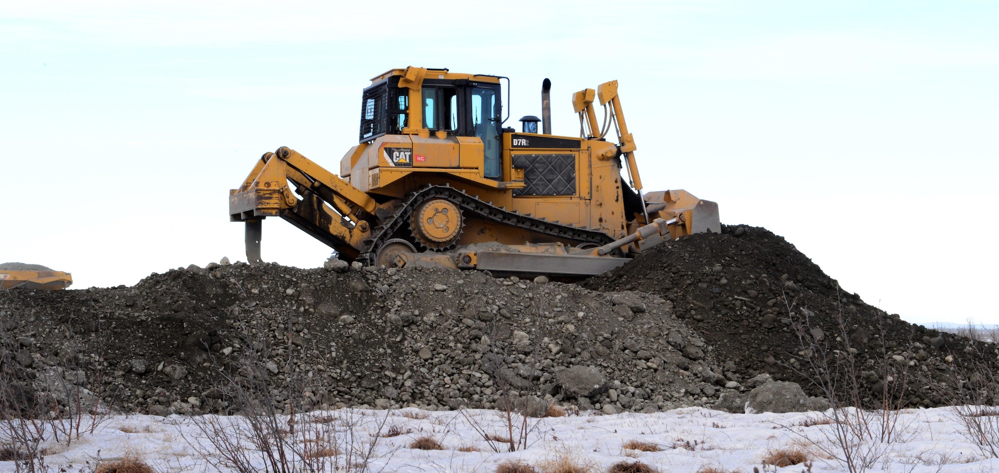 A bulldozer operated by a 354th Civil Engineer Squadron “dirt boy”, pushes dirt into place to create a trail system March 2, 2016, in Delta Junction, Alaska. The 354th CES “dirt boyz” and structural craftsman Airmen work for approximately 38 days to prepare the Oklahoma Range for RED FLAG-Alaska’s strategic training mission. (U.S. Air Force photo by Airman 1st Class Cassandra Whitman/Released)