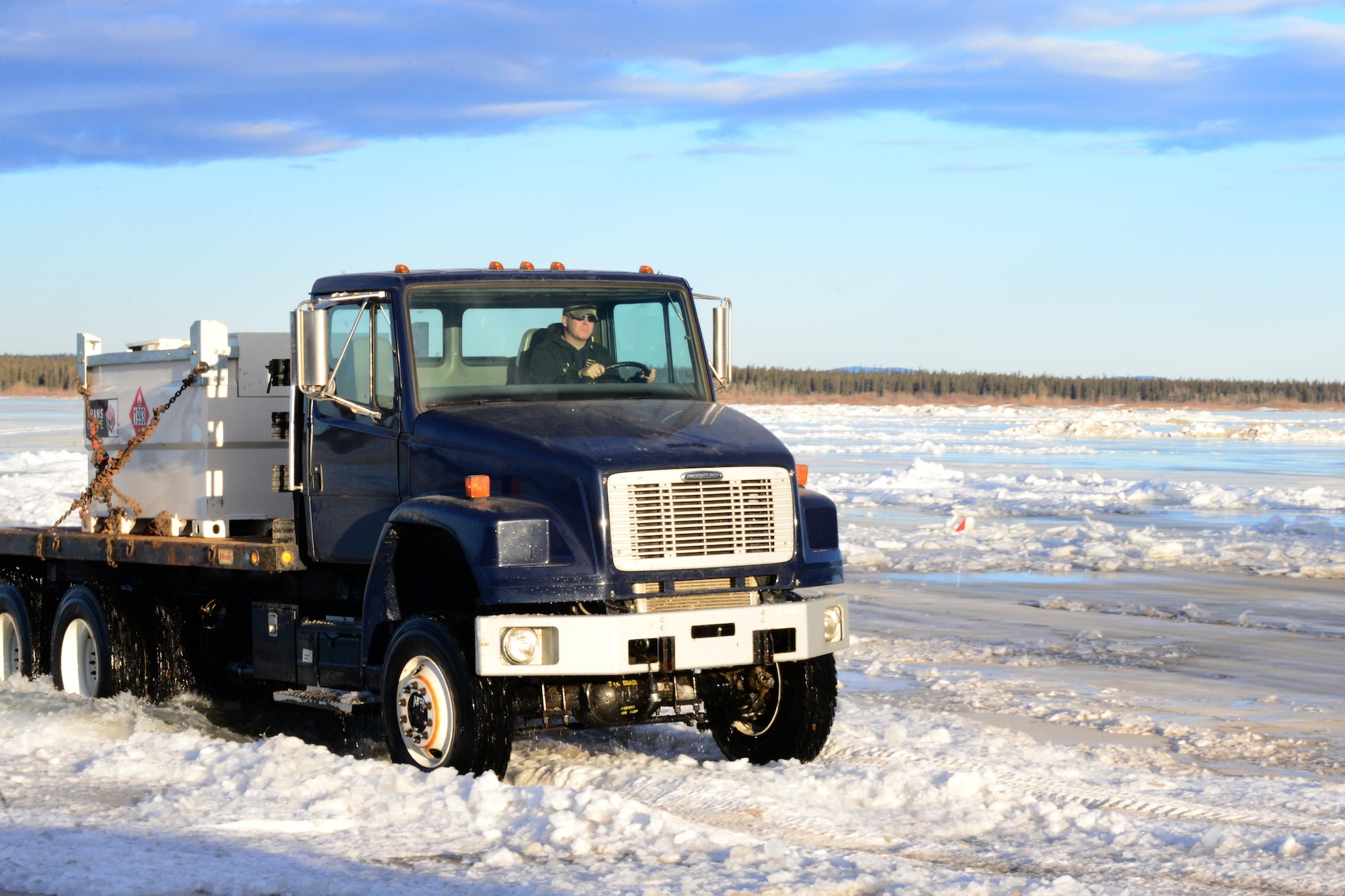 Tech. Sgt. John Jockusch, the 354th Civil Engineer Squadron noncommissioned officer in charge of range structural maintenance, drives a truck over the ice bridge in Delta Junction, Alaska, March 2, 2016. The ice bridge is used to get to and from the Oklahoma Range, part of RED FLAG-Alaska’s strategic training area, and is built by Airmen, soldiers and DoD civilians. (U.S. Air Force photo by Airman 1st Class Cassandra Whitman/Released)