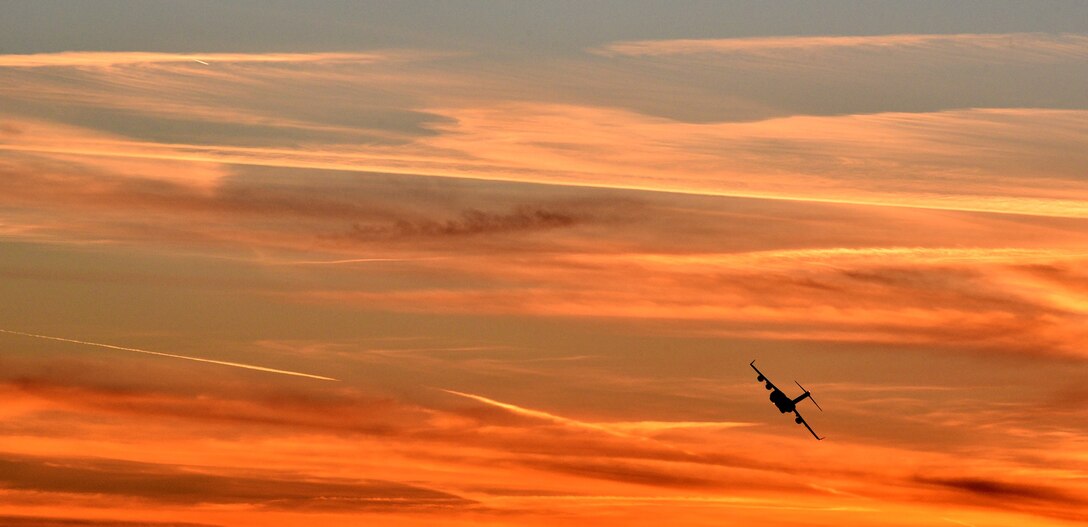 Pilots from the 89th Airlift Squadron guide a C-17 Globemaster III into the setting sun over Wright-Patterson Air Force Base, Ohio during a local flight March 2, 2016.