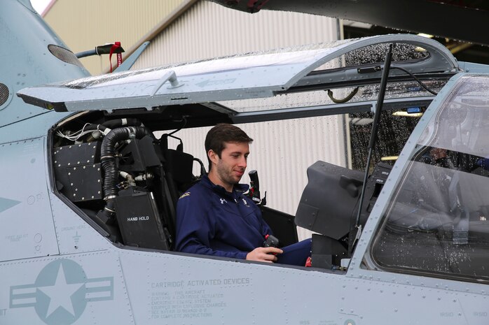 A member of the Notre Dame Lacrosse Team, University of Notre Dame, sits in the back seat of an aircraft at Marine Corps Aircraft Wing, Marine Corps Base Camp Pendleton, Calif., March 7. Marines with Marine Light Attack Helicopter Squadron 267 explained to the students the importance of having two pilots manning the aircraft, which is pivotal when it comes to communication during dangerous combat situations.