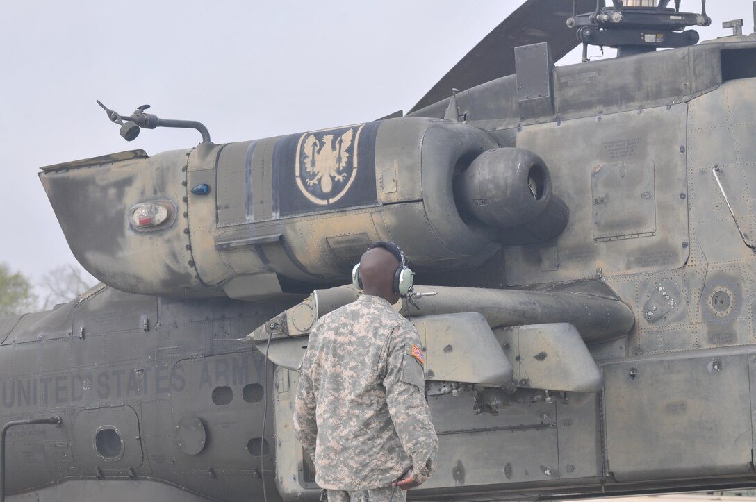 A 1-158th Assault Reconnaissance Battalion (ARB) soldier conducts a final maintenance check on the AH-64 Apache Helicopter before its ceremonial final flight in Conroe, Texas, Mar. 6, 2016. 1-158th ARB is a direct reporting unit to the 11th Theater Aviation Command. The 11th Theater Aviation Command (TAC) is the only aviation command in the Army Reserve. (U.S. Army Photo by Capt. Matthew Roman, 11th Theater Aviation Command Public Affairs Officer)