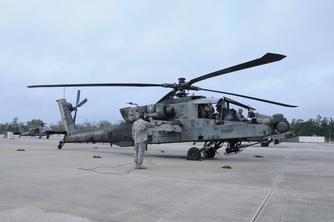Crewmembers from 1-158th Assault Reconnaissance Battalion (ARB), conduct final maintenance checks on the AH-64 Apache Helicopter before its ceremonial final flight in Conroe, Texas, Mar. 6, 2016. 1-158th ARB is a direct reporting unit to the 11th Theater Aviation Command. The 11th Theater Aviation Command (TAC) is the only aviation command in the Army Reserve. (U.S. Army Photo by Capt. Matthew Roman, 11th Theater Aviation Command Public Affairs Officer)