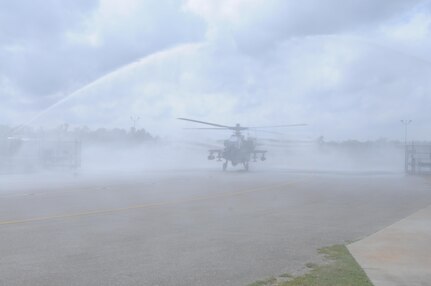 An AH-64 Apache Helicopter, from 1-158th Assault Reconnaissance Battalion (ARB), taxis under fire hoses during a ceremony in Conroe, Texas, to commemorate the final flight of the Apache helicopter in the U.S. Army Reserve, Mar. 6, 2016. 1-158th ARB is a direct reporting unit to the 11th Theater Aviation Command. The 11th Theater Aviation Command (TAC) is the only aviation command in the Army Reserve. (U.S. Army Photo by Capt. Matthew Roman, 11th Theater Aviation Command Public Affairs Officer)