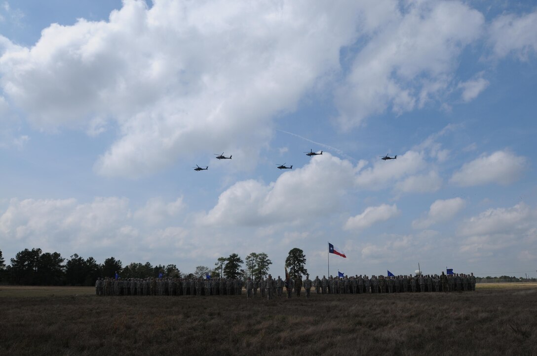 Soldiers from, 1-158th Assault Reconnaissance Battalion (ARB), stand in a battalion formation as five AH-64 Apache Helicopter conduct a ceremonial “fly-over”, in Conroe, Texas, to commemorate the final flight of the Apache helicopter in the U.S. Army Reserve, Mar. 6, 2016. 1-158th ARB is a direct reporting unit to the 11th Theater Aviation Command. The 11th Theater Aviation Command (TAC) is the only aviation command in the Army Reserve. (U.S. Army Photo by Capt. Matthew Roman, 11th Theater Aviation Command Public Affairs Officer)