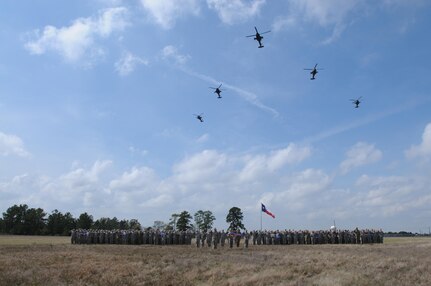 Soldiers from, 1-158th Assault Reconnaissance Battalion (ARB), stand in a battalion formation as five AH-64 Apache Helicopter conduct a ceremonial “fly-over”, in Conroe, Texas, to commemorate the final flight of the Apache helicopter in the U.S. Army Reserve, Mar. 6, 2016. 1-158th ARB is a direct reporting unit to the 11th Theater Aviation Command. The 11th Theater Aviation Command (TAC) is the only aviation command in the Army Reserve. (U.S. Army Photo by Capt. Matthew Roman, 11th Theater Aviation Command Public Affairs Officer)