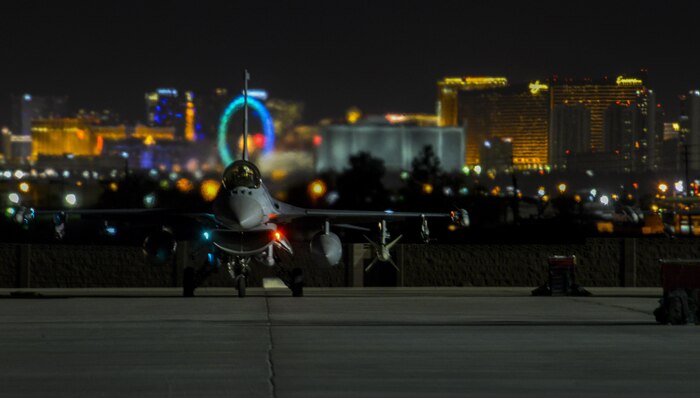 An F-16 Fighting Falcon sits on the flightline prior to take-off during a night exercise at Nellis Air Force Base, Nev., March 4, 2016. In addition to daytime operations, Red Flag conducts training exercises during the hours of darkness to train for low visibility environments. (U.S. Air Force photo by Airman 1st Class Kevin Tanenbaum)