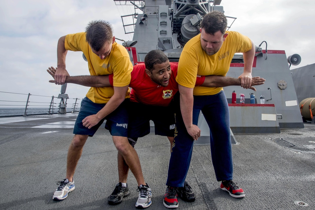 Navy Chief Petty Officer Andrew Feliciano, center, teaches sailors takedown techniques during security force training aboard the USS Chung-Hoon in the South China Sea, March 4, 2016. The guided-missile destroyer is on a regularly scheduled deployment. Feliciano is a master-at-arms. Navy photo by Petty Officer 2nd Class Marcus L. Stanley
