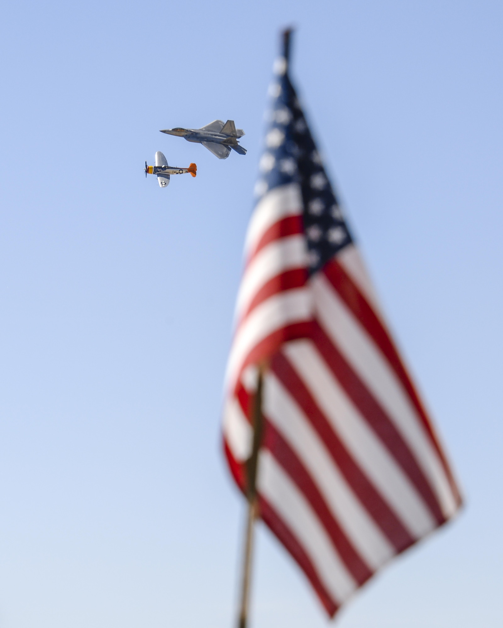 A U.S. Air Force F-22 Raptor and a P-51 Mustang fly in formation during the 2016 Heritage Flight Training and Certification Course at Davis-Monthan Air Force Base, Ariz., March 4, 2016. Established in 1997, the HFTCC certifies civilian pilots of historic military aircraft and U.S. Air Force pilots to fly in formation together during the upcoming air show season. (U.S. Air Force photo by Senior Airman Chris Massey/Released)