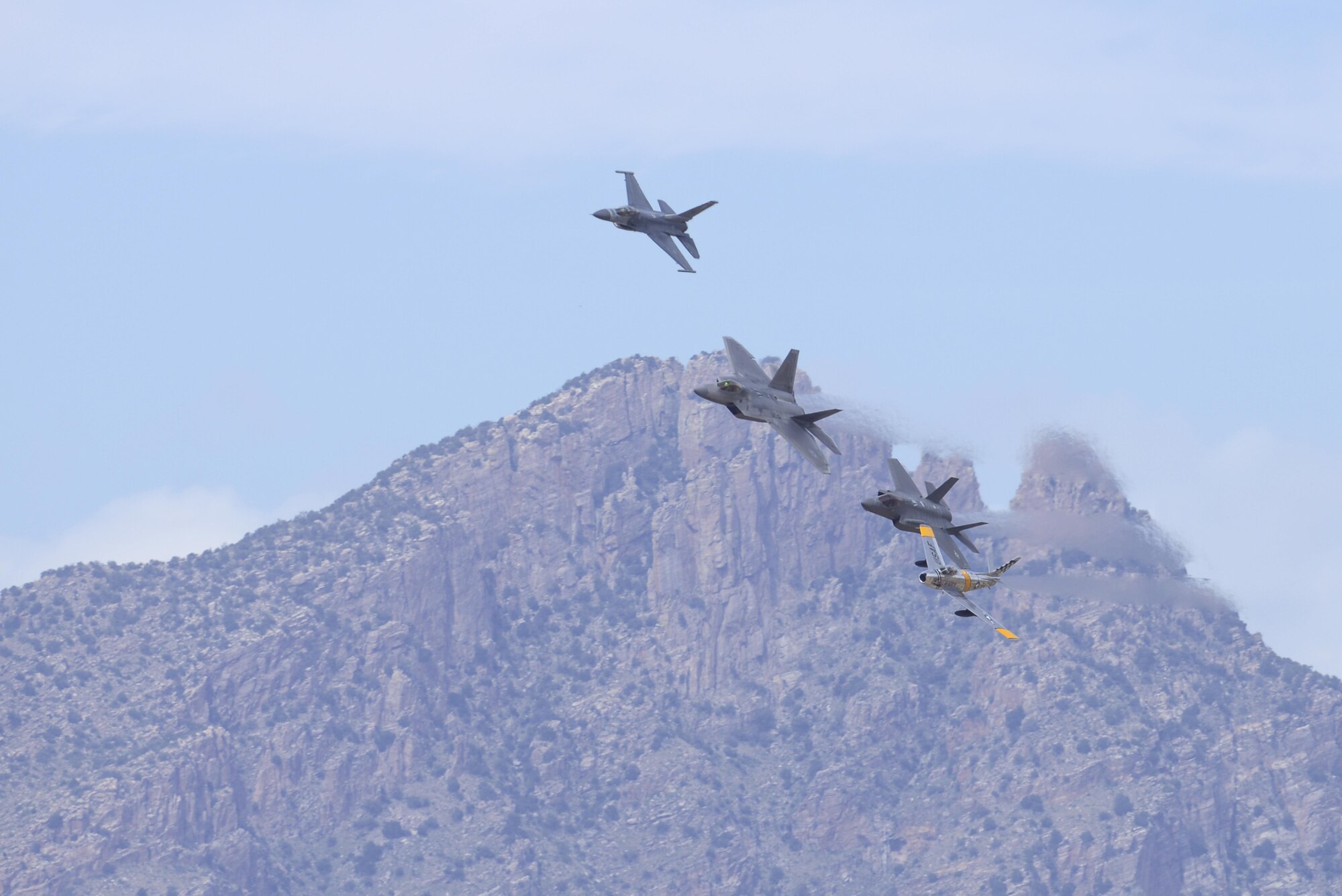 An F-16 Fighting Falcon, F-22 Raptor, F-35 Lightning II and an F-86 Sabre fly in formation during the 2016 Heritage Flight Training and Certification Course at Davis-Monthan Air Force Base, Ariz., March 6, 2016. Established in 1997, the HFTCC certifies civilian pilots of historic military aircraft and U.S. Air Force pilots to fly in formation together during the upcoming air show season. (U.S. Air Force photo by Senior Airman Chris Massey/Released)