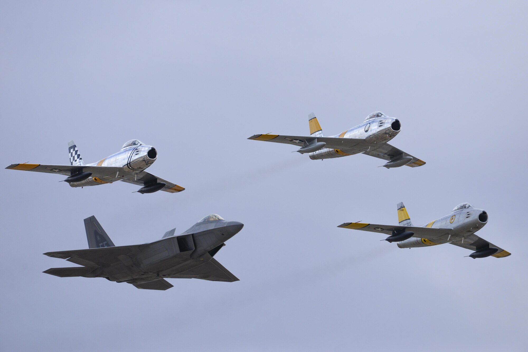 Three F-86 Sabres and a U.S. Air Force F-22 Raptor fly in formation during the 2016 Heritage Flight Training and Certification Course at Davis-Monthan Air Force Base, Ariz., March 6, 2016. Established in 1997, the HFTCC certifies civilian pilots of historic military aircraft and U.S. Air Force pilots to fly in formation together during the upcoming air show season. (U.S. Air Force photo by Senior Airman Chris Massey/Released)