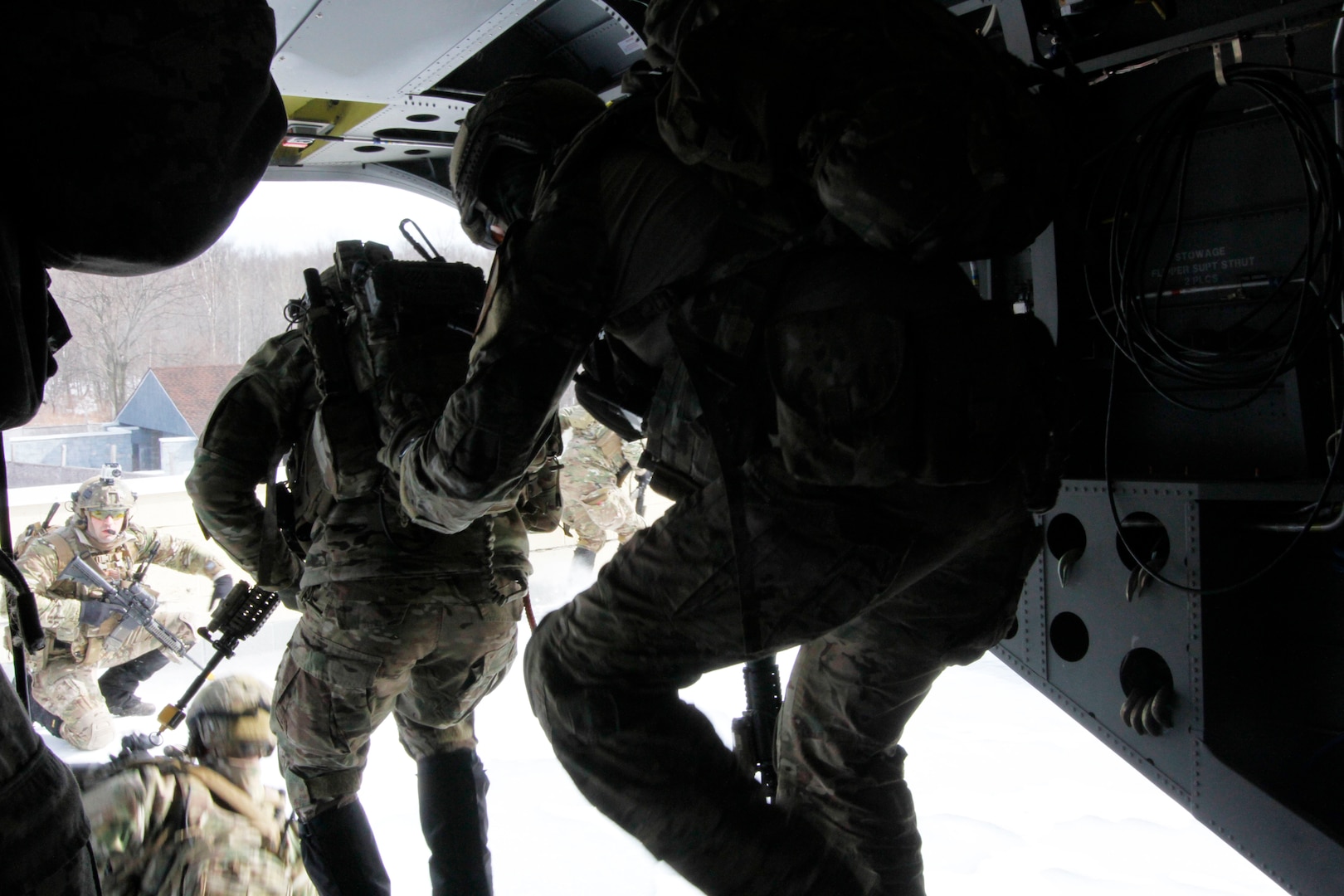New York Air National Guard joint terminal air controllers (JTAC)  from the 274th Air Support Operations Squadron disembark from New York Army National Guard CH-47F  Chinook helicopter that landed on top of a building at Fort Drum's urban combat training center  during a training exercise with  Company B, 3rd Battalion, 126th Aviation on Saturday, March 5, 2016. 