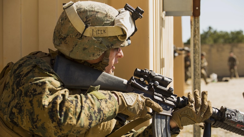 Lance Cpl. Aaron Meek, a military policeman with Bravo Company, 2nd Law Enforcement Battalion, observes a village during tactical site exploitation training at Marine Corps Base Camp Lejeune, N.C., March 3, 2016. The training allowed 2nd LEB to conduct raids and forensics operations to retain procedures regarding criminal prosecution.