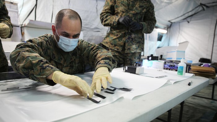Sgt. Alberto Camacho, military policeman for Charlie Company, 2nd Law Enforcement Battalion, separates evidence without fingerprints during tactical site exploitation training at Marine Corps Base Camp Lejeune, N.C., March 3, 2016. The training emphasizes the importance of leaving the evidence in pristine condition to ensure they get the most accurate intelligence necessary to identify the enemies.