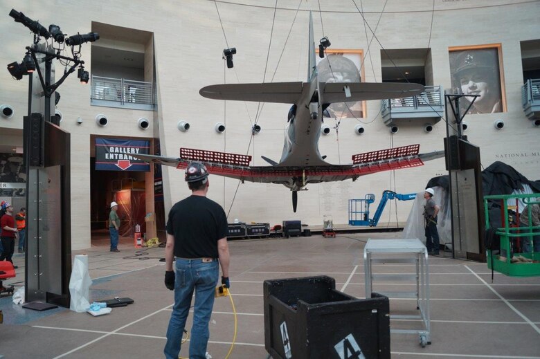 A rebuilt Dauntless being set in place in the Marine Corps Museum