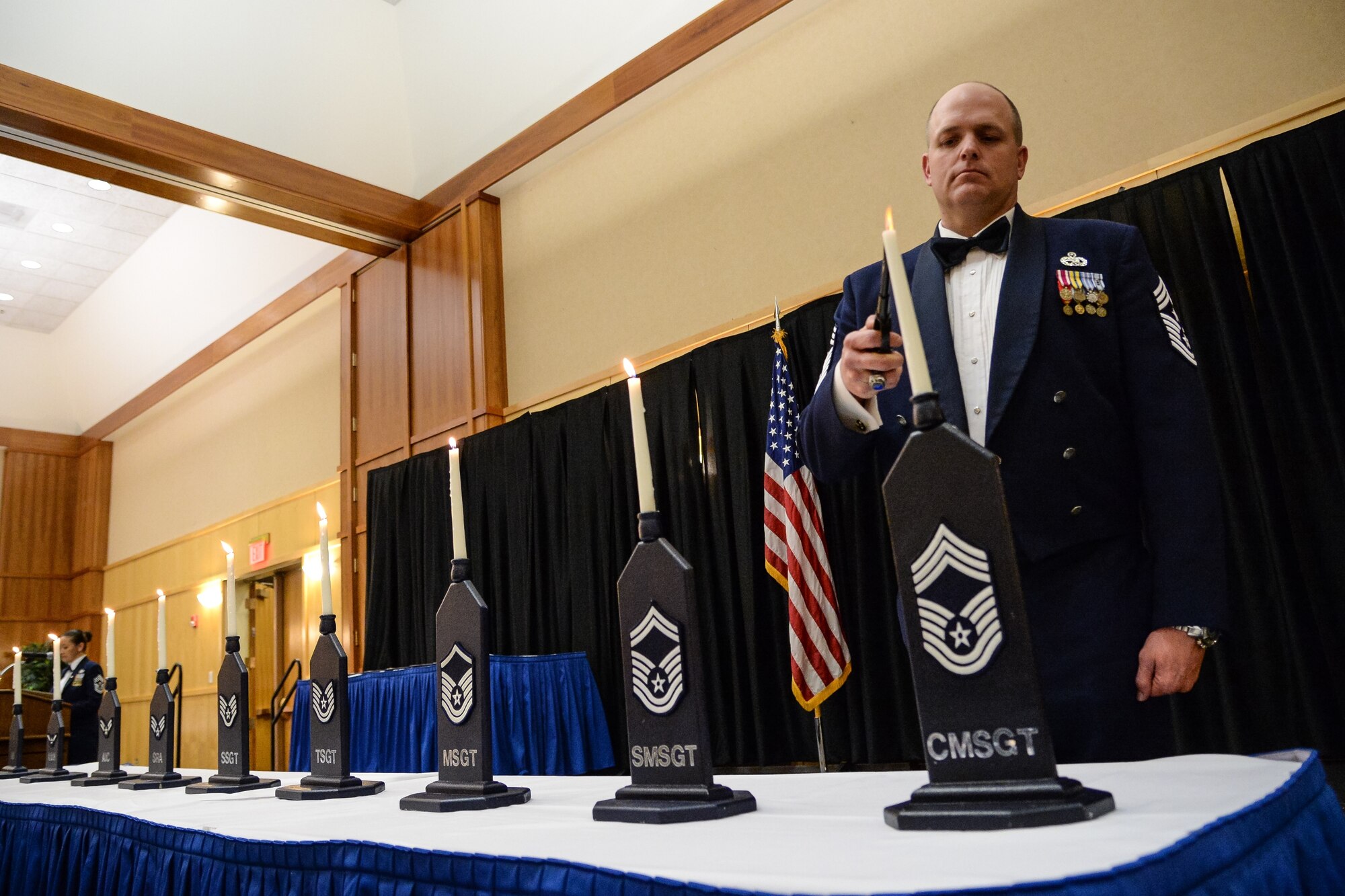 Utah Air National Guard Command Chief Master Sergeant Michael Edwards lights a candle representing the rank of chief master sergeant during the Chief’s Recognition Ceremony at Hill Air Force Base, Utah, March 4, 2016. (U.S. Air Force photo by R. Nial Bradshaw)