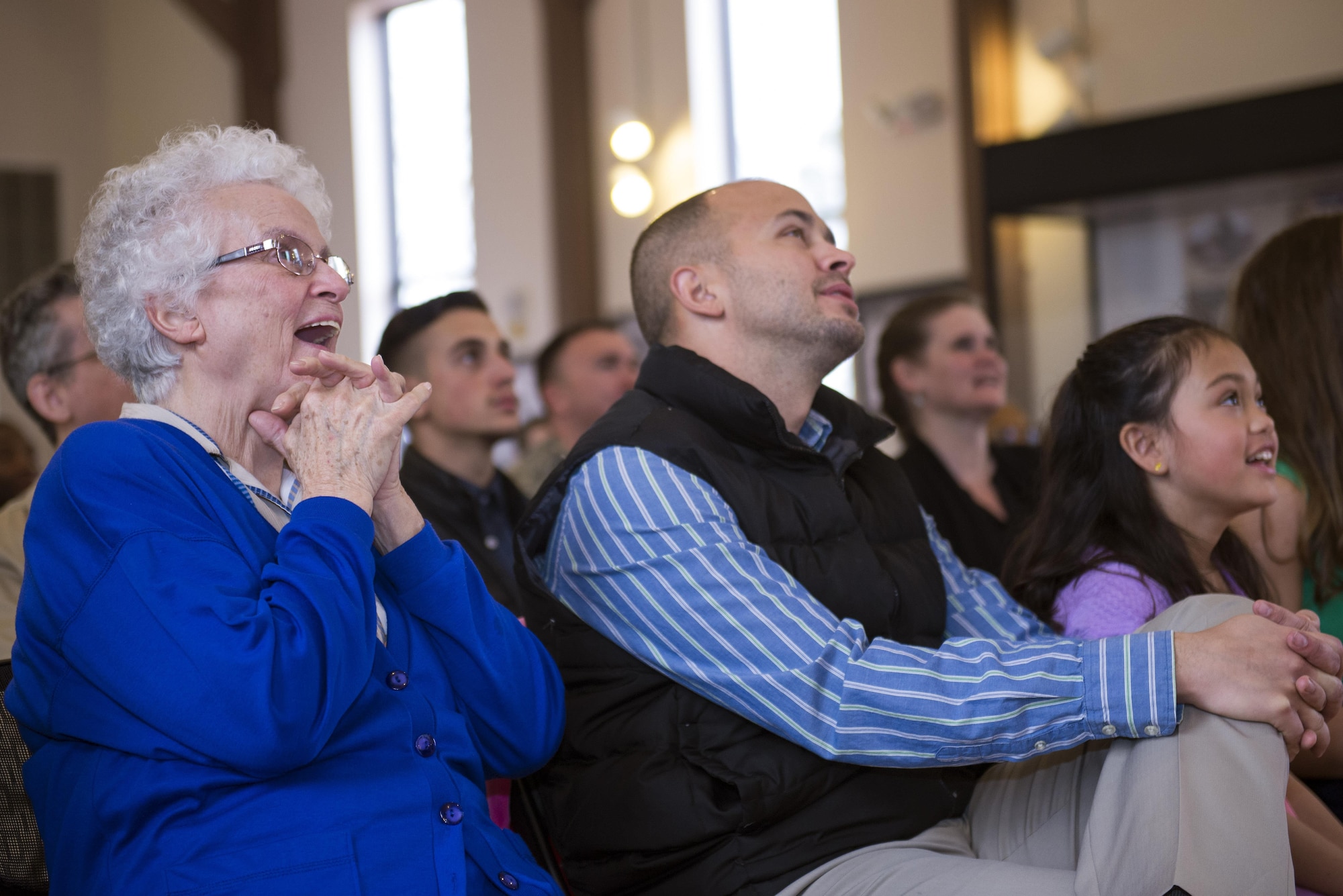 Family members of U.S. Air Force Chief Master Sgt. Edward Dyson, 336th Recruiting Squadron superintendent, watch a video presentation during Dyson’s retirement ceremony, March 4, 2016, at Moody Air Force Base, Ga. The video highlighted Dyson’s 30 years of service to the Air Force. (U.S. Air Force photo by Airman 1st Class Greg Nash/Released) 