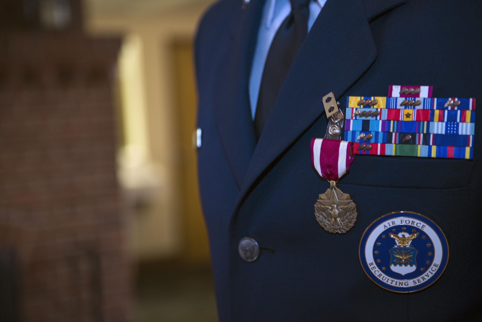 A Meritorious Service Medal rests on U.S. Air Force Chief Master Sgt. Edward Dyson’s uniform during his retirement ceremony, March 4, 2016, at Moody Air Force Base, Ga.  As the 336th Recruiting Squadron superintendent, Dyson led nearly 100 members to recruit approximately 3,000 new Airmen and 50 officers during his tenure. (U.S. Air Force photo by Airman 1st Class Greg Nash/Released) 