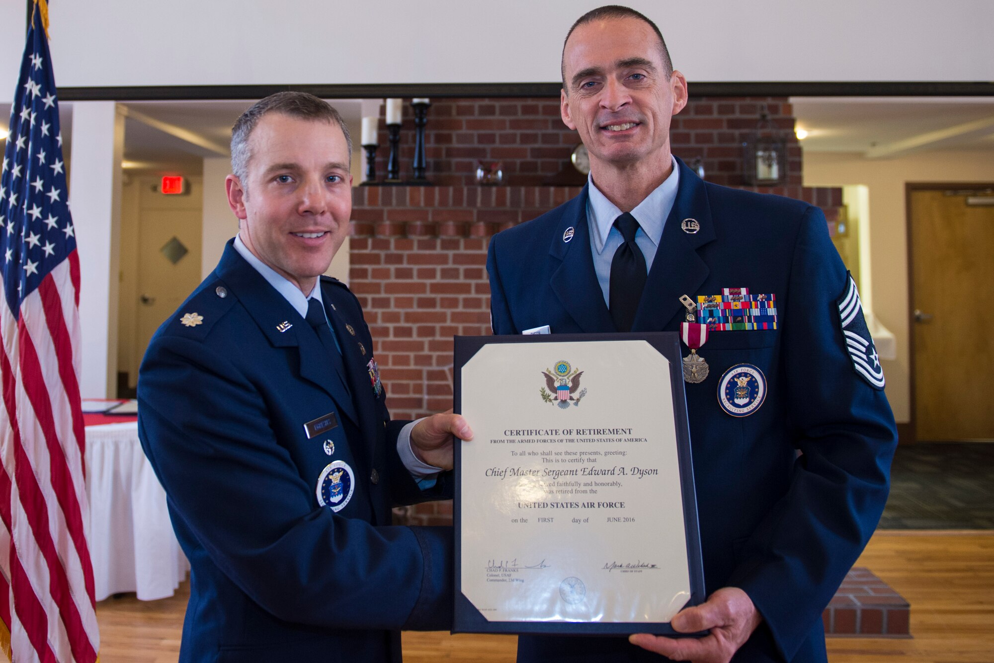 U.S. Air Force Lt. Col. Joseph Egresits, 336th Recruiting Squadron commander, presents Chief Master Sgt. Edward Dyson, 336th Recruiting Squadron superintendent, with a certificate of retirement during Dyson’s retirement ceremony, March 4, 2016, at Moody Air Force Base, Ga. Dyson was responsible for equipping, training, and managing approximately 100 personnel in a three-state vicinity covering nearly 85,000 square-miles. (U.S. Air Force photo by Airman 1st Class Greg Nash/Released) 
