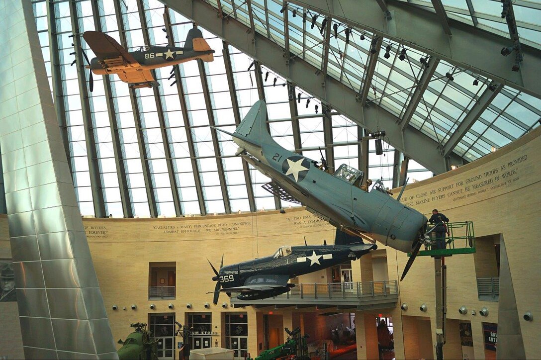The restored SBD-3 Dauntless is hoisted into place at the National Museum of the Marine Corps. The Museum is closed until April 1 for renovations.