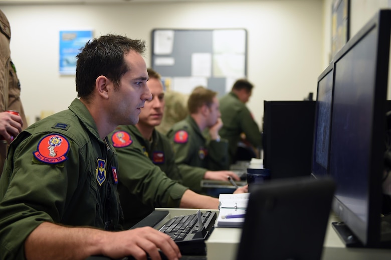 U.S. Air Force Capt. Wes Wilkening, 58th Airlift Squadron inputs objective area information during the planning phase of Altus Air Force Base Quarterly Exercise Program ALTEX 16A, March 3, 2016, inside the mission planning room at Altus AFB, Okla. The main objective for the exercise was formal training unit development and creating a realistic tactical scenario that relates to the current emerging tactical mission requirements in the Middle East. (U.S. Air Force photo by Senior Airman Dillon Davis/Released)