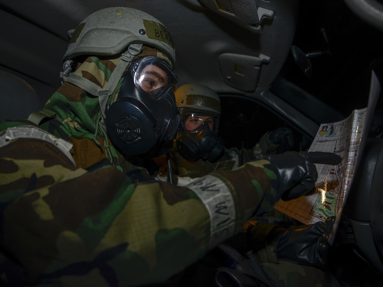 Airmen 1st Class Benjamin Thompson and Justin Eason, 51st Civil Engineer Squadron emergency management apprentices, review survey areas during exercise Beverly Midnight 16-01 on Osan Air Base, Republic of Korea, March 8, 2016. The emergency management teams are the first to respond after attacks to search for injured personnel, enemy activity and structural damage. (U.S. Air Force photo by Senior Airman Kristin High/Released)