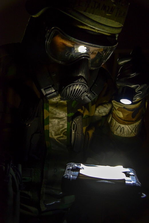 Airman 1st Class Benjamin Thompson, 51st Civil Engineer Squadron emergency management apprentice, checks simulated M-8 paper for chemicals during exercise Beverly Midnight 16-01 on Osan Air Base, Republic of Korea, March 8, 2016. The exercise is used to create realistic training environments for Airmen to practice key skills in the event of real-world contingencies. The emergency management teams are the first to respond after attacks to search for injured personnel, enemy activity and structural damage. (U.S. Air Force photo by Senior Airman Kristin High/Released) 