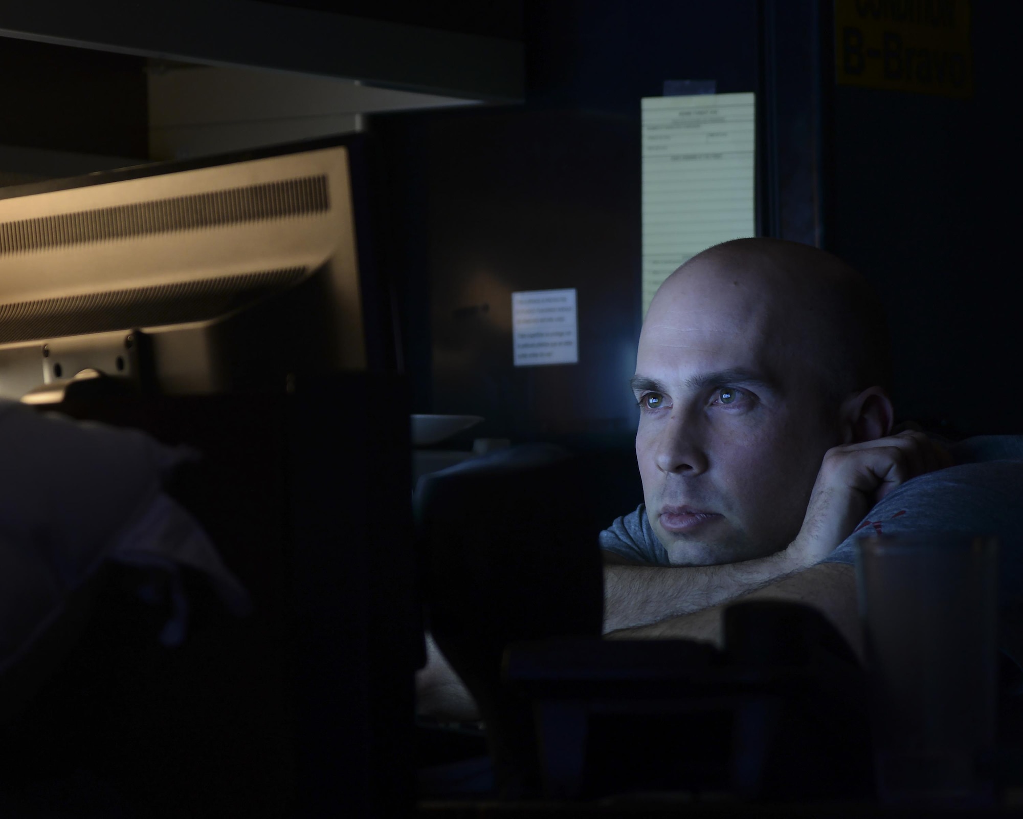 Staff Sgt. Jason Pominski, 319th Missile Squadron facility manager, watches a video during his downtime Feb. 8, 2016, at a Missile Alert Facility in the F.E. Warren Air Force Base, Wyo., missile complex. Facility managers lead the topside enlisted Airmen in MAFs and take care of the grounds and facility. (U.S. Air Force photo by Senior Airman Jason Wiese)