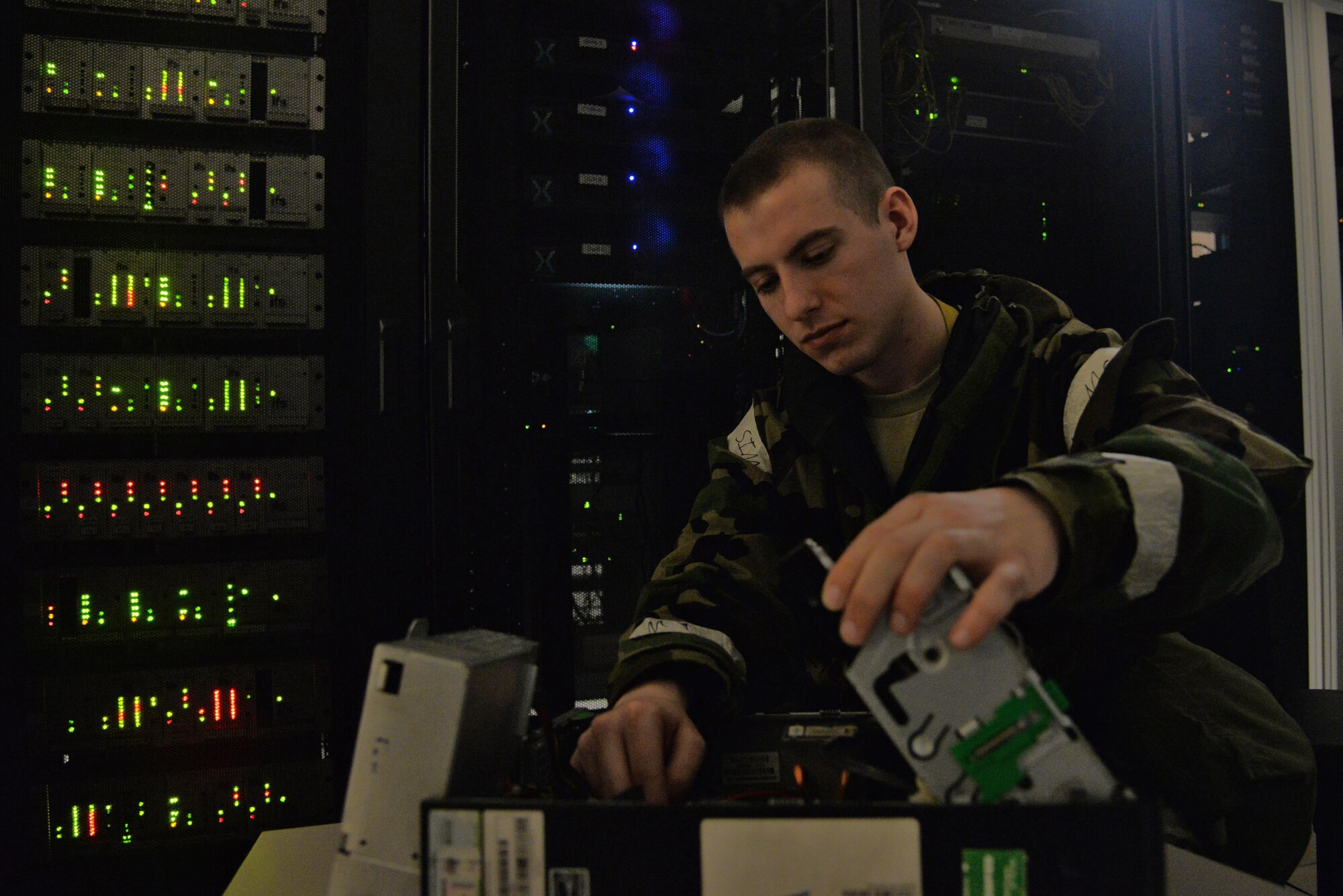 Senior Airman Darian Hodges, 51st Communications Squadron client systems technician, replaces a hardware component of a computer during exercise Beverly Midnight 16-01 on March 8, 2016, at Osan Air Base, Republic of Korea. Hodges and his communications team are responsible for the proper maintenance of more than 100 workstations in the emergency operations center. BM 16-01 is an exercise designed to test the warfighting capabilities of units under the 51st Fighter Wing with a focus on readiness, defending the base and executing flying operations.  (U.S. Air Force photo by Tech. Sgt. Travis Edwards/Released)