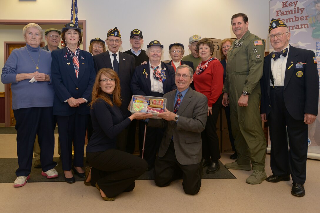 Members of the American Legion Auxiliary Post 838 pose with members of the 914th Airlift Wing at the Airman & Family Readiness Center on February 29, 2016. The Auxiliary members delivered 200 care packages for deployed 914 AW members. (U.S. Air Force photo by Staff Sgt. Richard Mekkri/released)