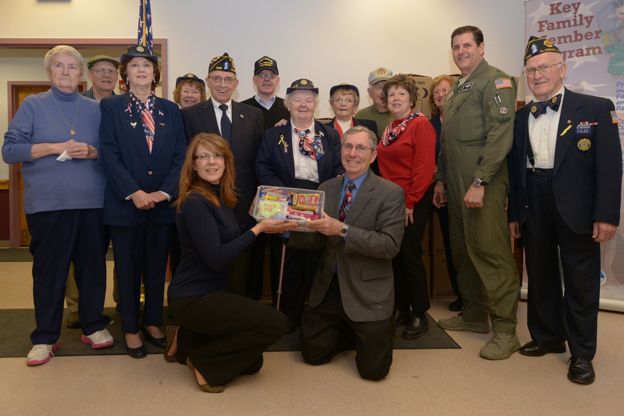 Members of the American Legion Auxiliary Post 838 pose with members of the 914th Airlift Wing at the Airman & Family Readiness Center on February 29, 2016. The Auxiliary members delivered 200 care packages for deployed 914 AW members. (U.S. Air Force photo by Staff Sgt. Richard Mekkri/released)