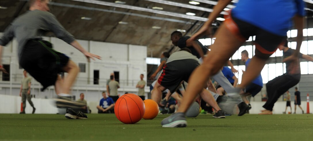 Airmen from the 28th Communications Squadron and Bomb Wing Staff rush to begin a game of dodgeball during the Air Force Assistance Fund kick-off at Ellsworth Air Force Base, S.D., Feb. 29, 2016. For more information about the different charitable organizations provided by the AFAF, call (800) 258-1413 for Air Force Enlisted Village, (800) 554-5510 for LeMay Foundation, (800) 655-3083 for Air Force Villages Charitable Foundation, and (703) 972-2650 for Air Force Aid Society. (U.S. Air Force photo by Airman 1st Class Denise M. Nevins/Released)