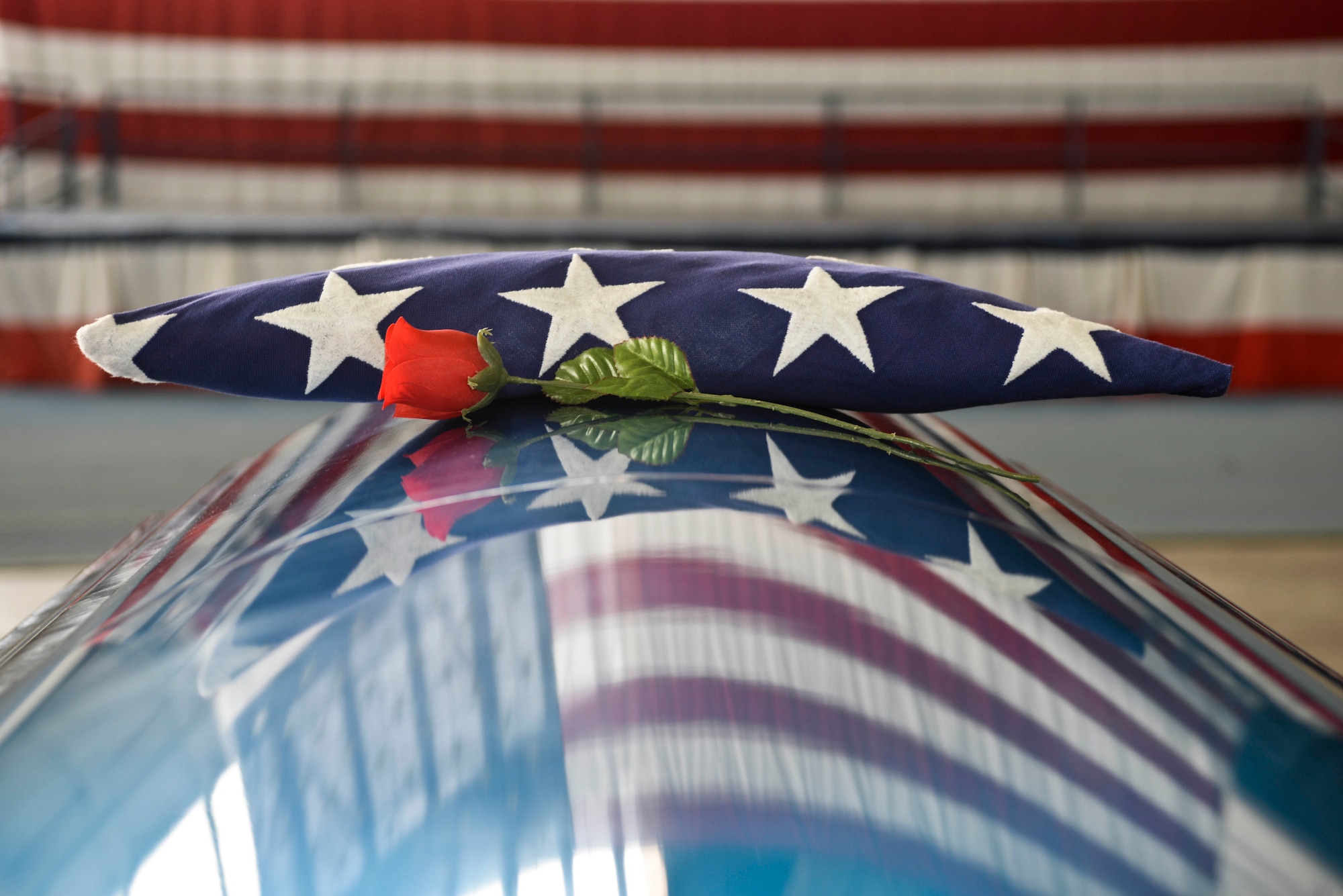 A folded flag sits on a casket during ceremonial funeral training at Ellsworth Air Force Base, S.D., Feb. 22, 2016. Search and recovery teams are in charge of finding, identifying and recovering remains of those who were lost in any incident, then bringing that individual back to their duty location where a ceremonial funeral is held. (U.S. Air Force photo by Airman Sadie Colbert/Released)