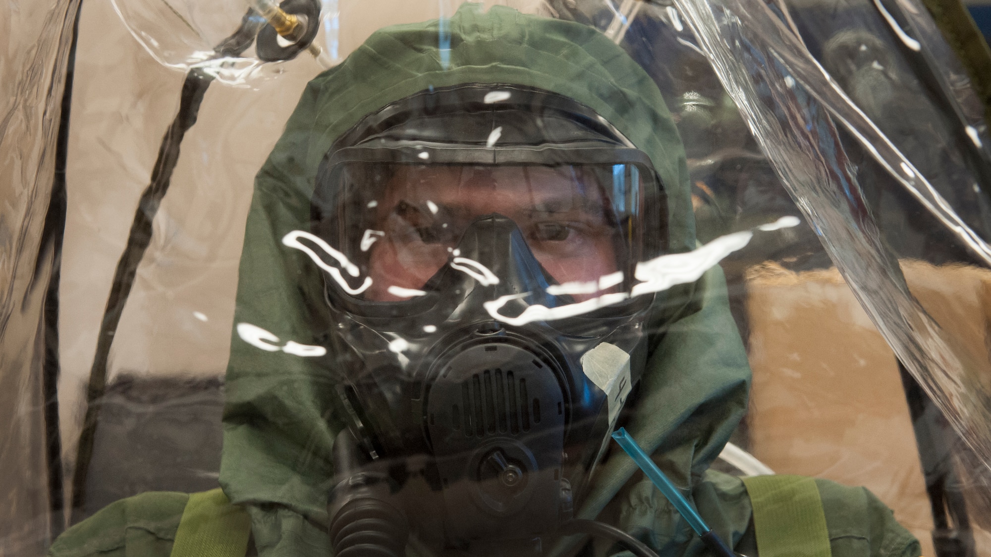 First Lt. Rich Gangloff, 3d Airlift Squadron pilot, wears the XM69 Aircrew Chemical, Biological, Radiological and Nuclear Defense (CBRN) system March 2, 2016, inside the Aircrew Flight Equipment facility on Dover Air Force Base, Del. Gangloff volunteered to wear the XM69 for long durations to test its comfort and endurance capabilities. (U.S. Air Force photo/Senior Airman Zachary Cacicia)