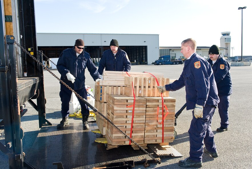 Members of Fairfax County Fire and Rescue Department, Va.: Virginia Task Force 1 unload shoring March 3, 2016, at the 436th Aerial Port Squadron marshalling yard on Dover Air Force Base, Del. The shoring was used to stabilize both 48-foot and 54-foot VTF 1 equipment and supply trailers after they were loaded onto a C-5M Super Galaxy as part of a training exercise for Team Dover personnel and Urban Search and Rescue Team members. (U.S. Air Force photo/Roland Balik)