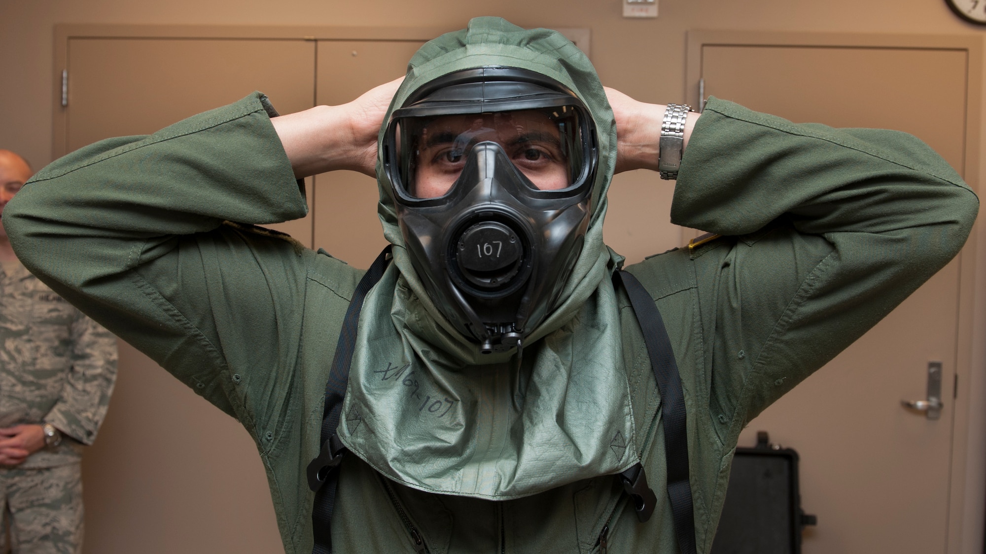 Capt. Edward Silva, 436th Operations Support Squadron Aircrew Flight Equipment commander, dons the XM69 Aircrew Chemical, Biological, Radiological and Nuclear Defense (CBRN) system March 2, 2016, inside the Aircrew Flight Equipment facility on Dover Air Force Base, Del. A Joint Service Aircrew Mask Strategic Program team partnered with the 436th OSS/AFE to conducted comfort and endurance wear trails and developmental tests on the XM69. (U.S. Air Force photo/Senior Airman Zachary Cacicia)
