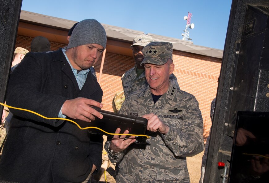 Lt. Gen. Stephen Wilson, deputy commander of U.S. Strategic Command, looks at new convoy technology with a 91st Security Forces Group member at Minot Air Force Base, N.D., Feb. 26, 2016. During his visit with the 91st SFG, Wilson was shown a variety of demonstrations to include convoy operations and various aspects of missile field activity. (U.S. Air Force photo/Airman 1st Class Christian Sullivan)