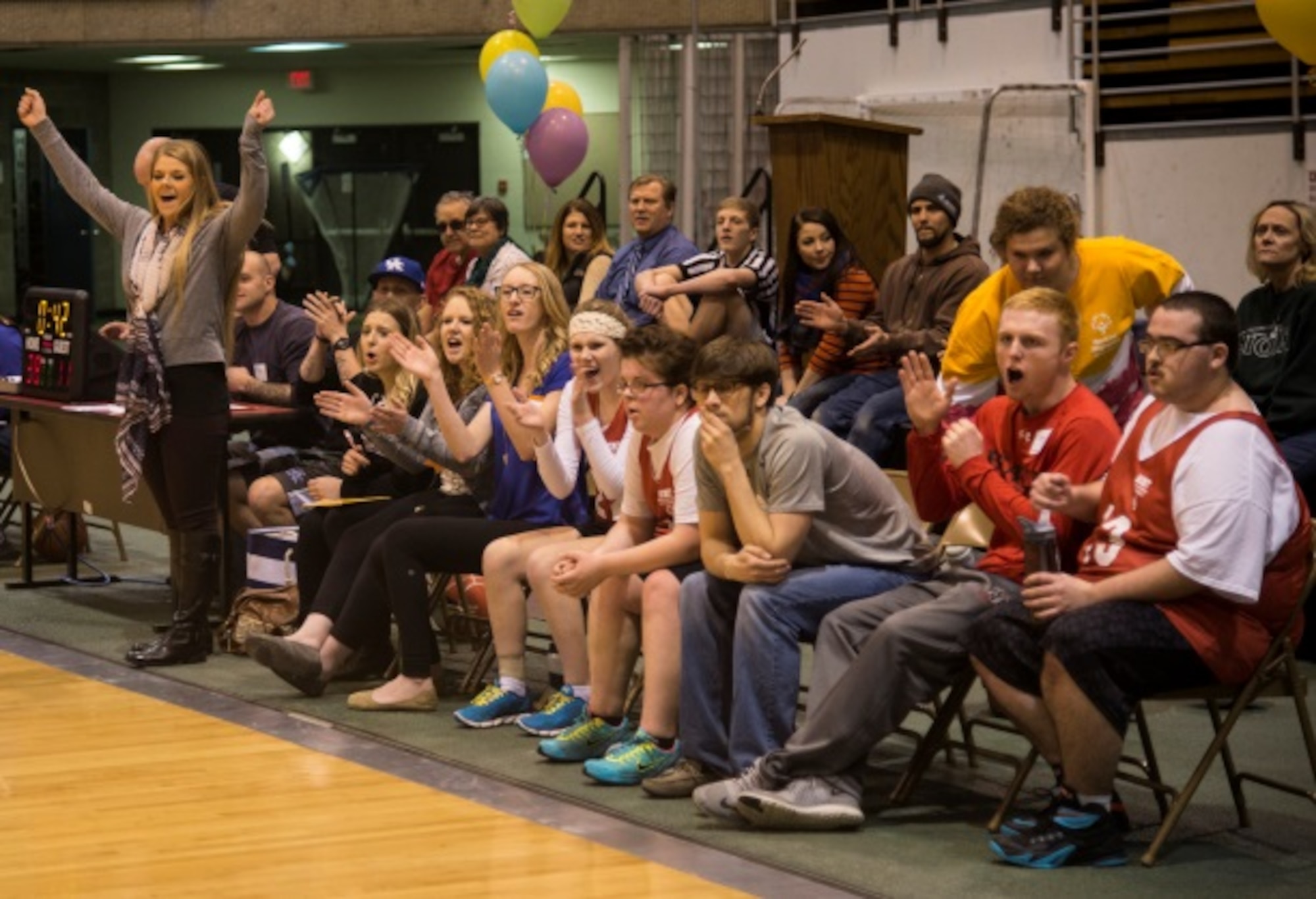 Participants and coaches cheer as their team scores a basket during the North Dakota Special Olympics in Minot, N.D., March 4, 2016. Minot Air Force Base members volunteered at the event as referees and other volunteer positions. (U.S. Air Force photo/Airman 1st Class Christian Sullivan)
