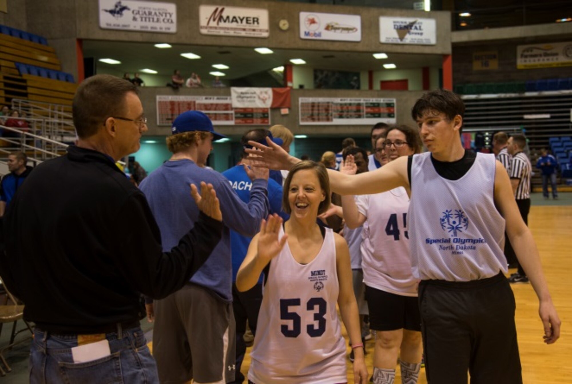 Members of the Minot Special Olympics team showcase their sportsmanship after a game at the North Dakota Special Olympics in Minot, N.D., March 4, 2016. Minot Air Force Base members volunteered at the event as referees and other volunteer positions. (U.S. Air Force photo/Airman 1st Class Christian Sullivan)