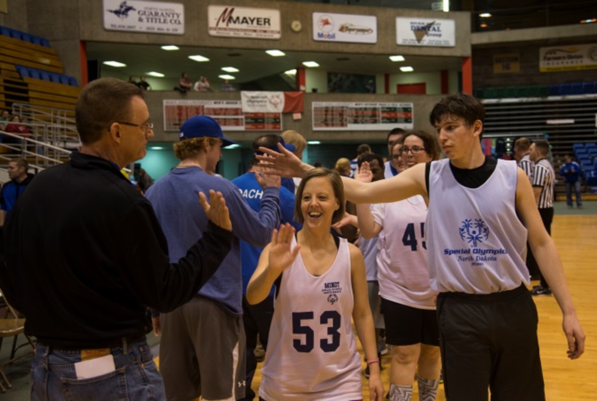 Members of the Minot Special Olympics team showcase their sportsmanship after a game at the North Dakota Special Olympics in Minot, N.D., March 4, 2016. Minot Air Force Base members volunteered at the event as referees and other volunteer positions. (U.S. Air Force photo/Airman 1st Class Christian Sullivan)