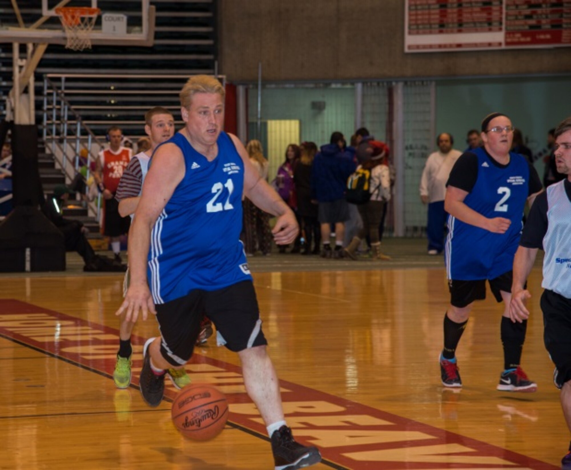 A member of the Jamestown Special Olympics team dribbles during a fastbreak during the North Dakota Special Olympics in Minot, N.D., March 4, 2016. Minot Air Force Base members volunteered at the event as referees and other volunter positions. (U.S. Air Force photo/Airman 1st Class Christian Sullivan)