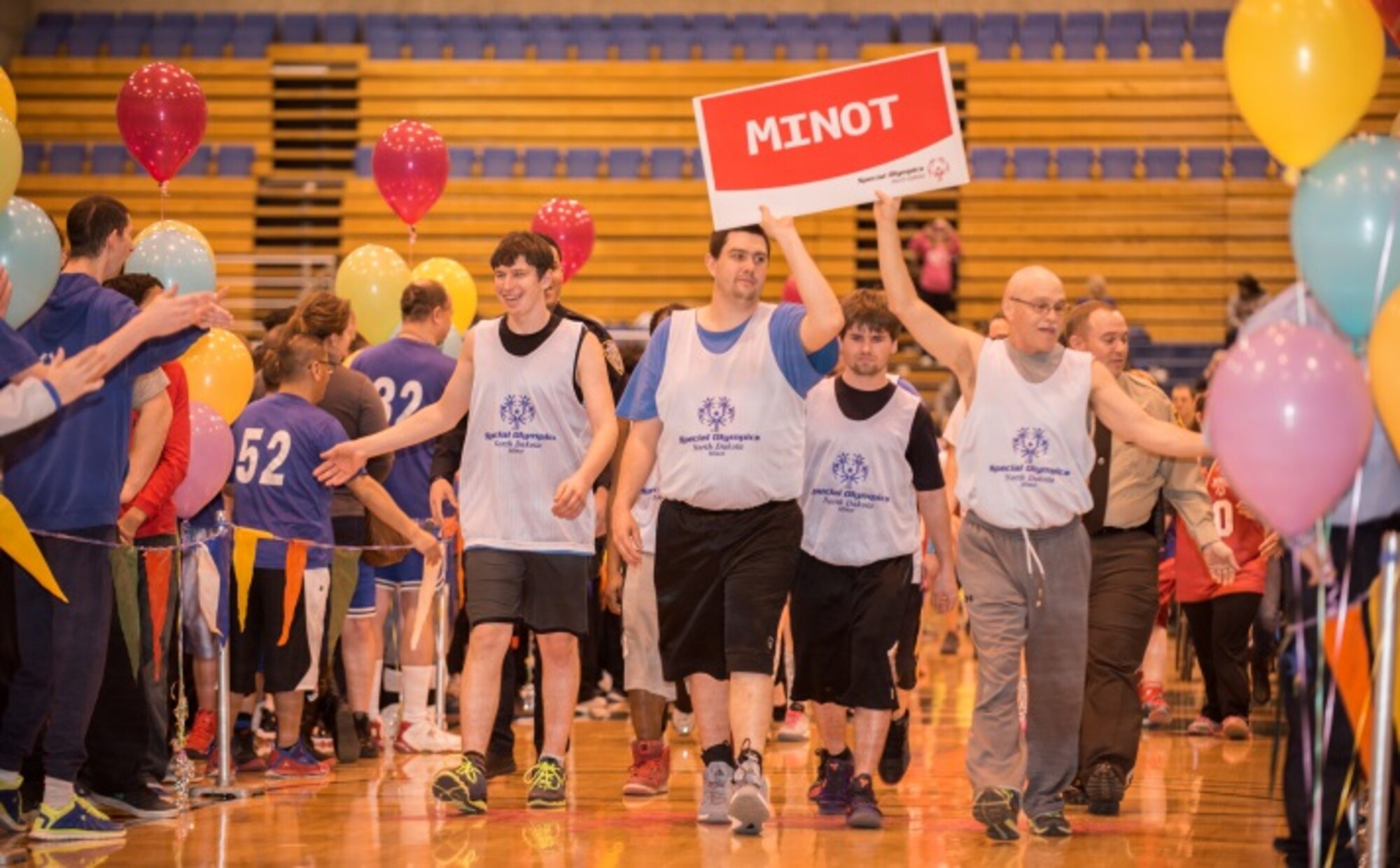 Members of the Minot Special Olympics team high-five other participants as their team is introduced at the North Dakota Special Olympics in Minot, N.D., March 4, 2016. Minot Air Force Base members volunteered at the event as referees and other volunteer positions. (U.S. Air Force photo/Airman 1st Class Christian Sullivan)