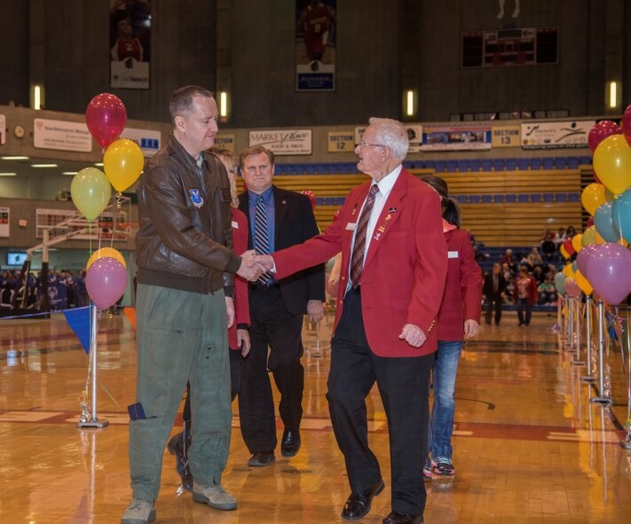 Col. David Ballew, 5th Bomb Wing vice commander, shakes hands with a Minot community member during the pre-game ceremonies at the North Dakota Special Olympics in Minot, N.D., March 4, 2016. Ballew and Col. Michael Lutton, 91st Missile Wing commander, among other Minot AFB members volunteered to help at the Special Olympics. (U.S. Air Force photo/Airman 1st Class Christian Sullivan)