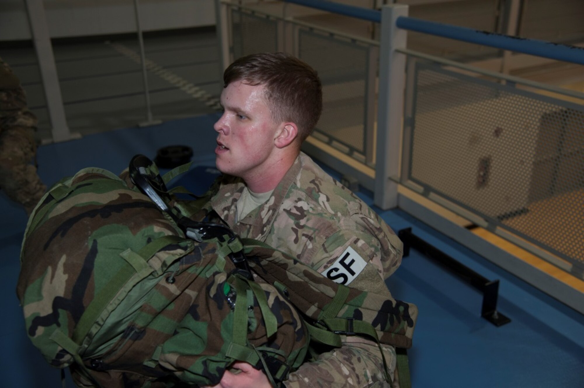 Airman 1st Class Brian Sneddon, 91st Missile Security Forces Sqaudron response force leader, performs a squat with full ruck gear in preparation for the Bataan Death March Ruck at Minot Air Force Base, N.D., Jan. 6, 2016. Participants have been preparing for the ruck since October and will depart for White Sands N.M. where the ruck will take place, in March. (U.S. Air Force photo/Airman 1st Class Christian Sullivan)