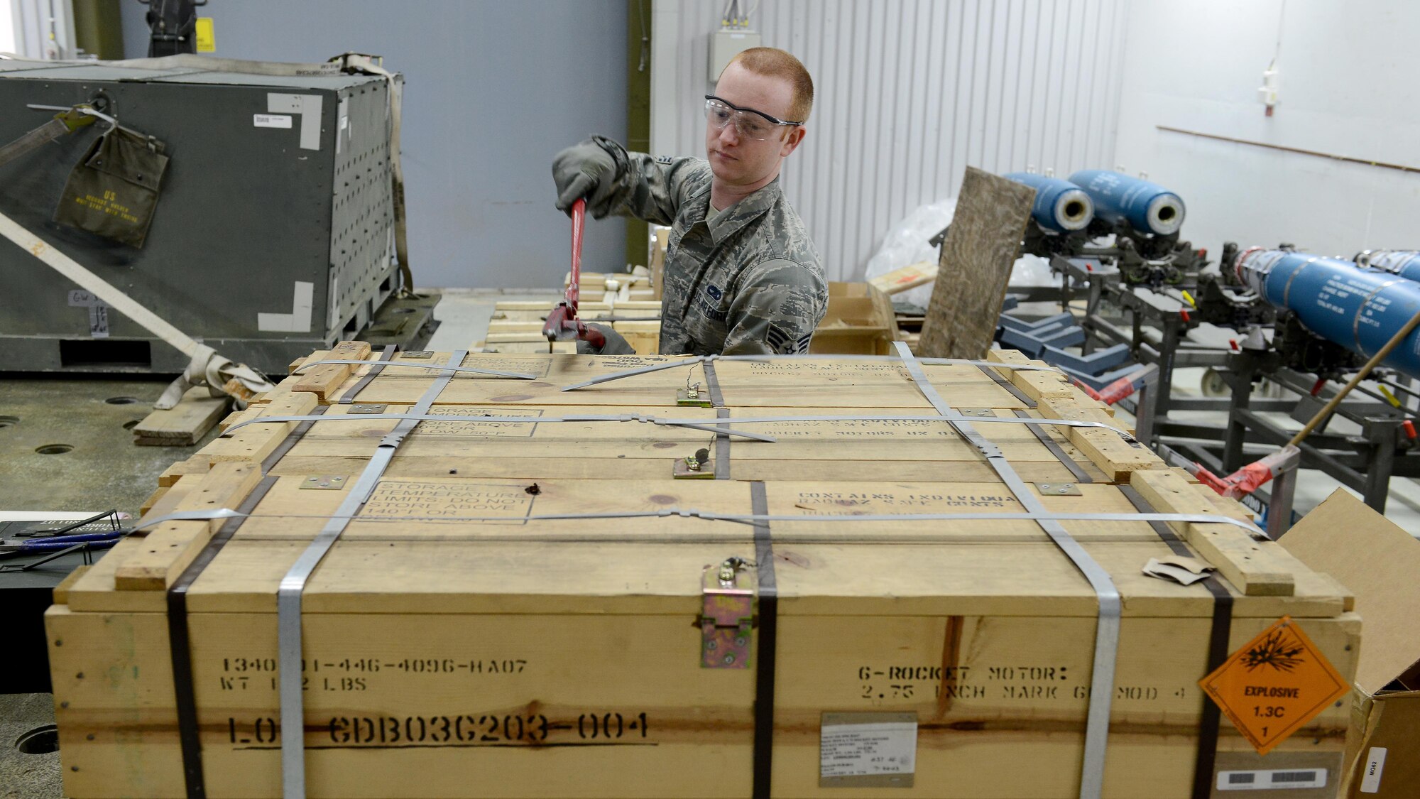 Senior Airman Jacob Diorio, 31st Munitions Squadron weapons support crew member, cuts the metal banding off a pallet of rocket motor boxes, March 3, 2016, at Bodø Main Air Station, Norway. Munitions Squadron Airmen built and delivered various practice bombs, rockets, and chaff and flares for F-16 Fighting Falcons during Exercise Cold Response 16. (U.S. Air Force photo by Tech. Sgt. R.J. Biermann/Released)