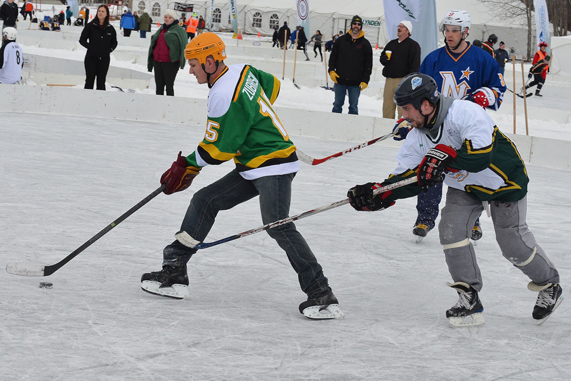 Air Force Staff Sgt. Tony Zubriski, an air traffic controller with the 3rd Operational Support Squadron skates the puck past an opposing player in her team’s third match of The Last Frontier Pond Hockey Classic hosted in Anchorage, Alaska March 5. Zubriski’s team finished the tournament with a match score of two losses, one win, and a tie in the open division. (U.S. Air Force photo by Airman 1st Class Kyle Johnson)