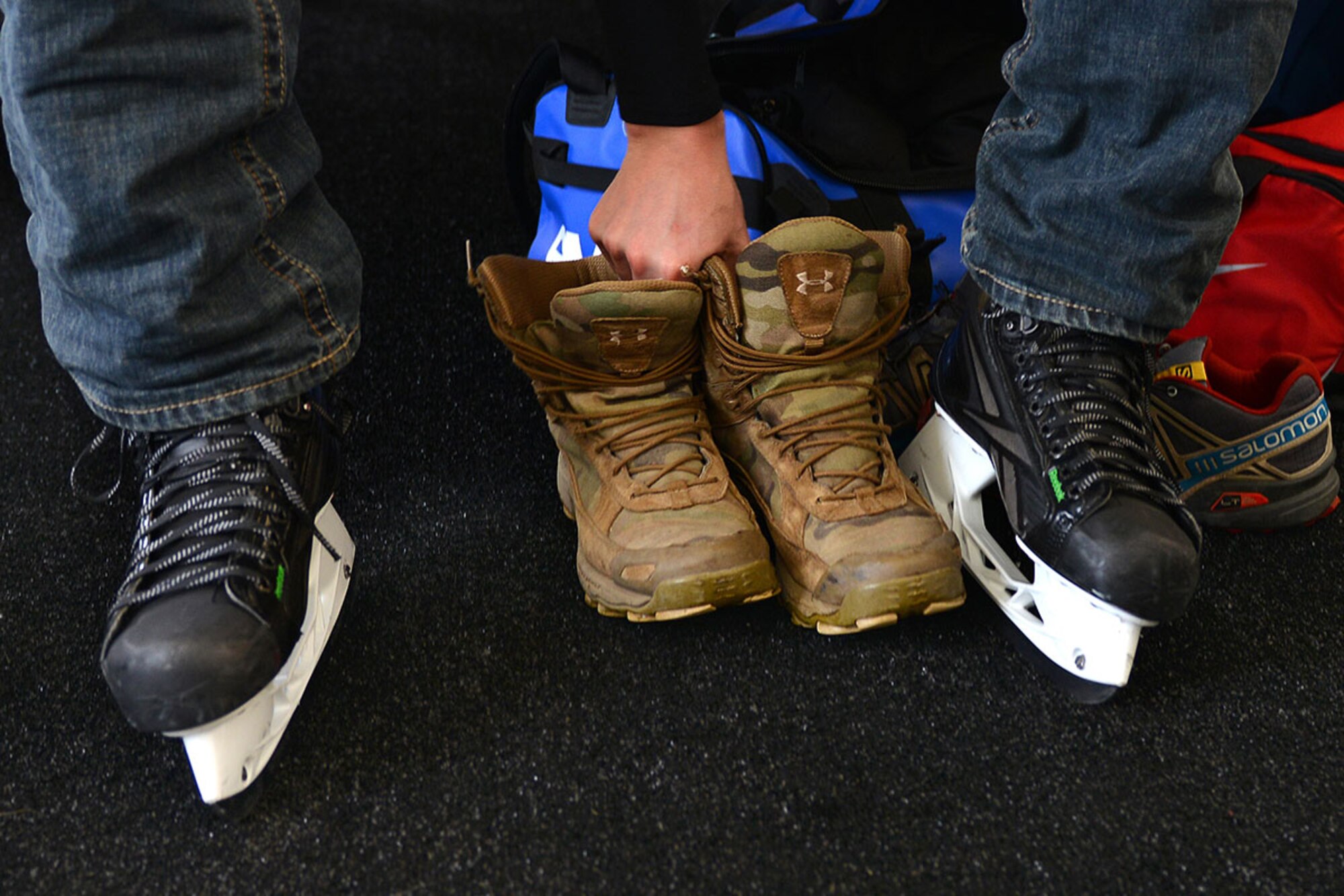 Air Force Staff Sgt. Tony Zubriski, an air traffic controller with the 3rd Operational Support Squadron places his boots aside after donning his hockey skates in preparation for his team’s final match of at The Last Frontier Pond Hockey Classic hosted in Anchorage, Alaska March 5. Zubriski and several other service members from Joint Base Elmendorf-Richardson, along with their friend Timothy McLain, formed a six-man team as one of 17 teams competing in the open division. (U.S. Air Force photo by Airman 1st Class Kyle Johnson)