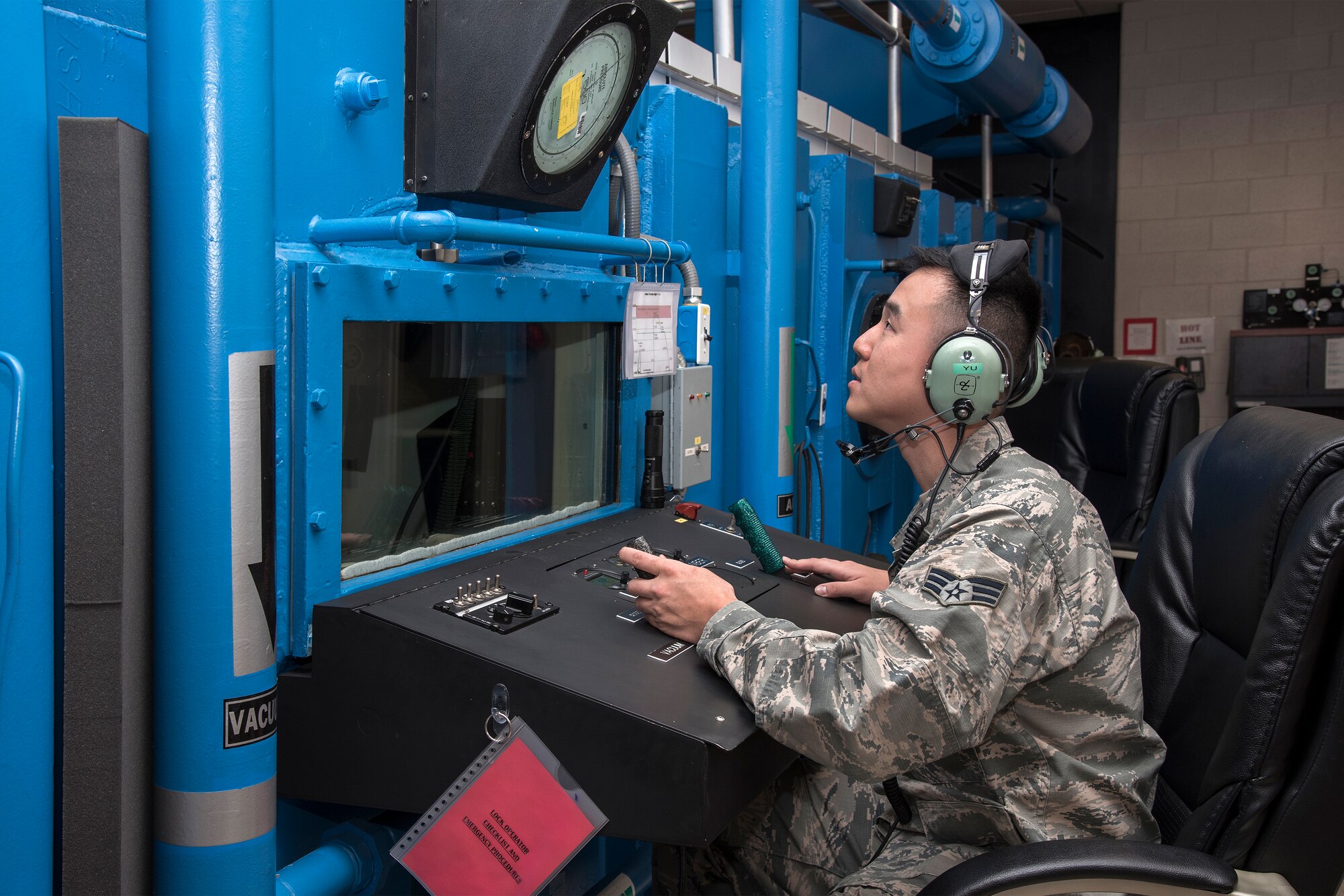 PETERSON AIR FORCE BASE, Colo. – Senior Airman Jae Yu, 21st Aerospace Medicine Squadron, monitors pressure in the altitude chamber at the Carter P. Luna Aerospace and Operational Physiology Training Center. Yu overcame the challenges of moving to the U.S. from South Korea as a young boy and later joined the Air Force. (U.S. Air Force photo by Craig Denton)