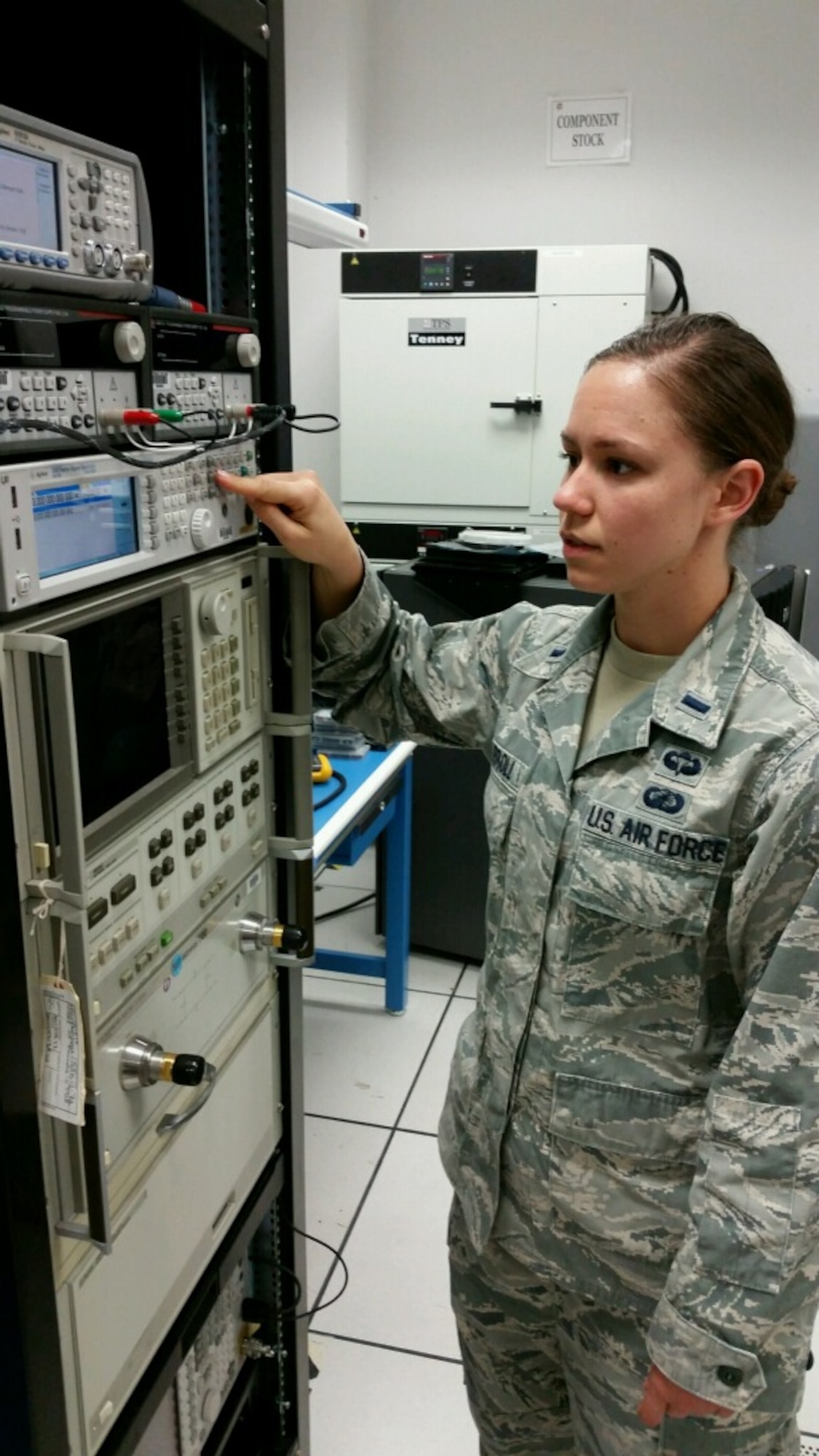 1st Lt. Katherine Carroll, Air Force Research Laboratory engineer, works at her AFRL lab with a spectrum analyzer for Global Positioning System signal testing. (Courtesy photo)