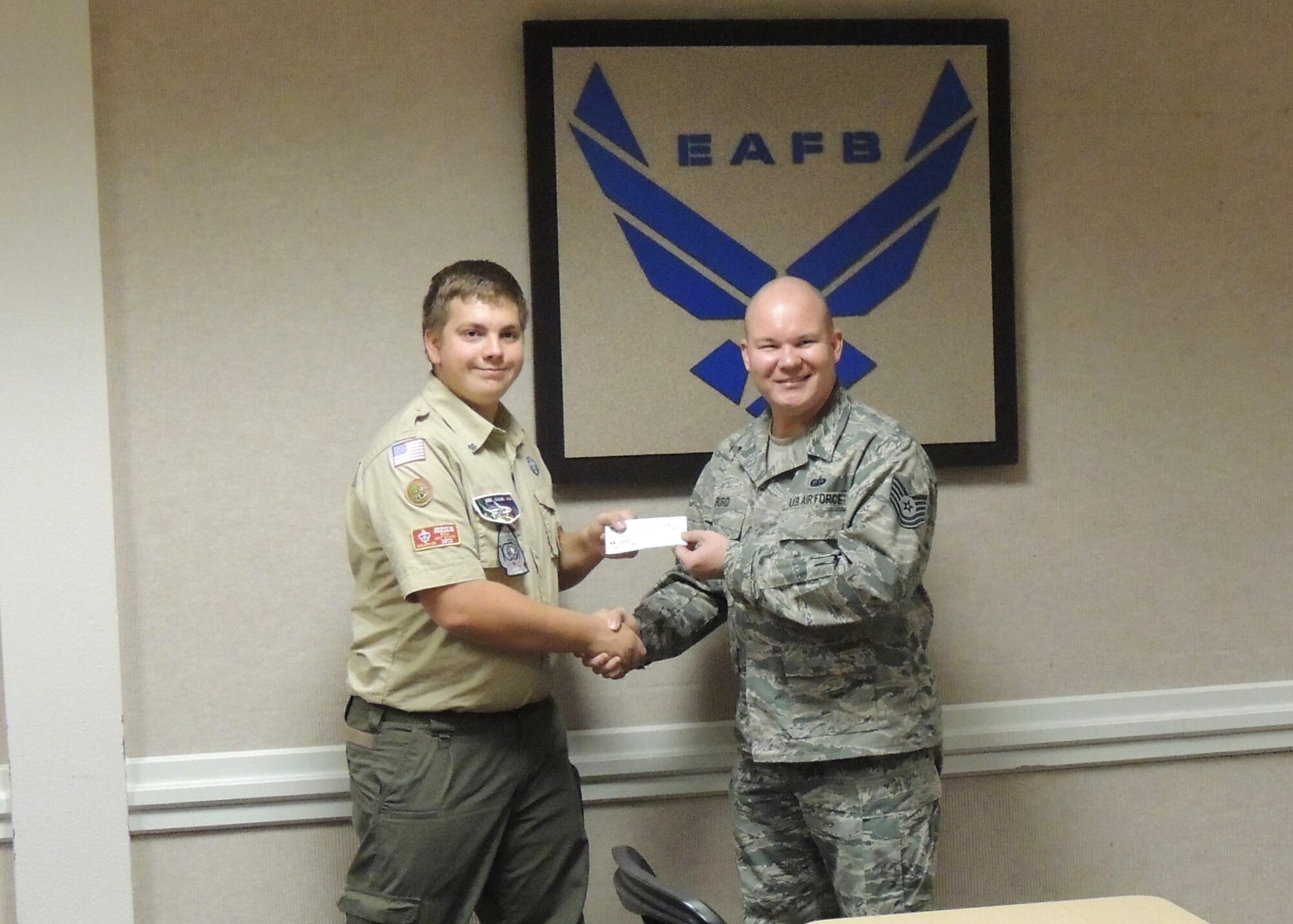 Life Scout Tristen Nelson received a check from Tech. Sgt. Michael Burd, Air Force Sergeants Association Chapter 1328 president, Feb. 26. The money was used to renovate the baseball field's outfield fence at Desert High School as an Eagle Scout project for Nelson. (Courtesy photo)